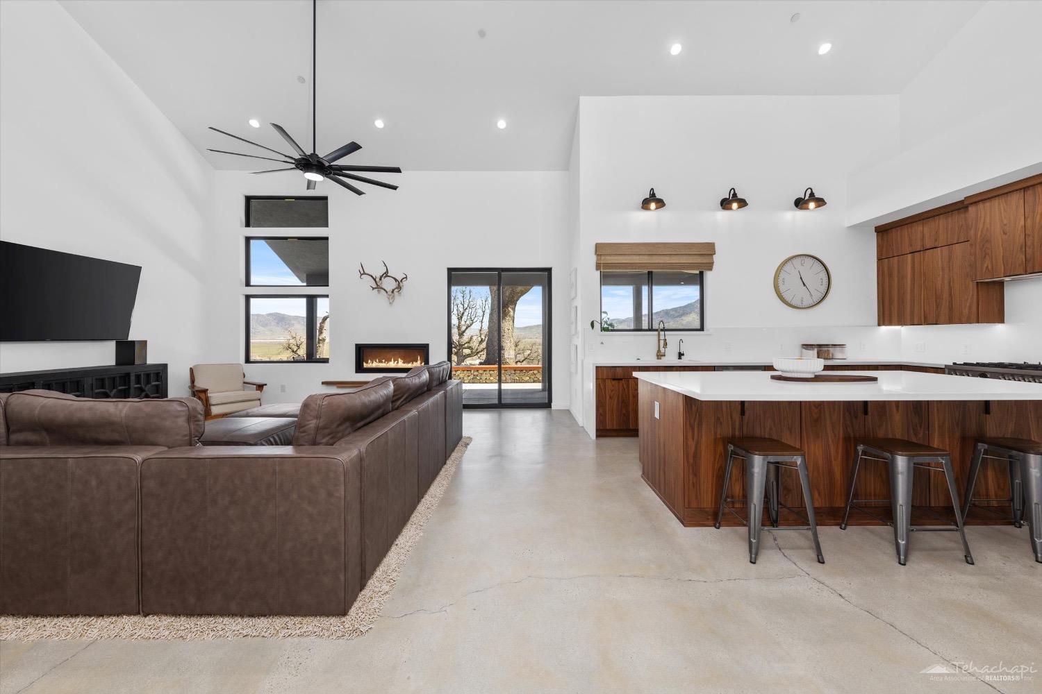 28901 Augusta Way Tehachapi, CA 93561 - Photo 16 of 65 a living room with stainless steel appliances kitchen island granite countertop furniture and a large window