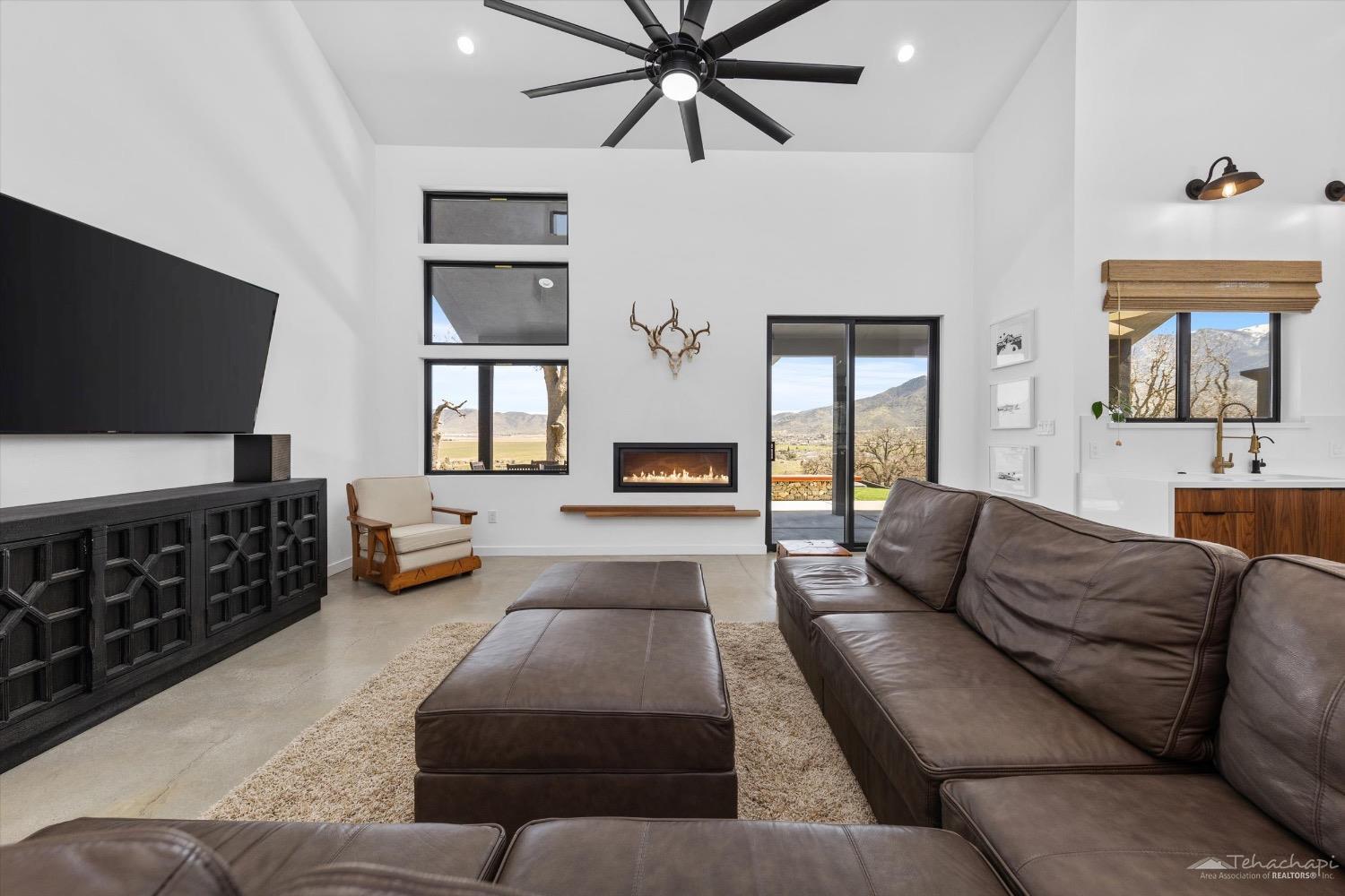28901 Augusta Way Tehachapi, CA 93561 - Photo 19 of 65 a living room with furniture fireplace and a flat screen tv