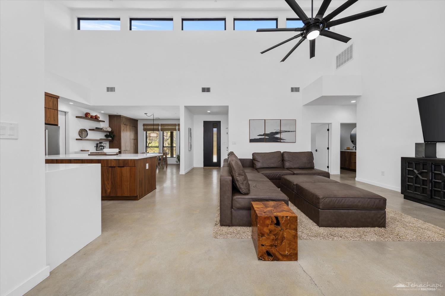 28901 Augusta Way Tehachapi, CA 93561 - Photo 23 of 65 a living room with furniture kitchen view and a wooden floor