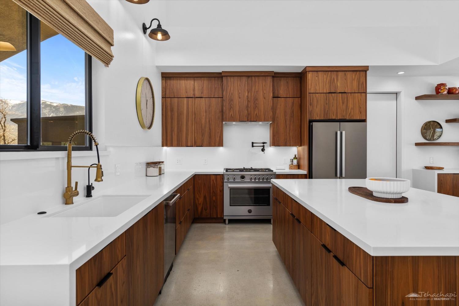 28901 Augusta Way Tehachapi, CA 93561 - Photo 31 of 65 a kitchen with stainless steel appliances a sink stove and a refrigerator