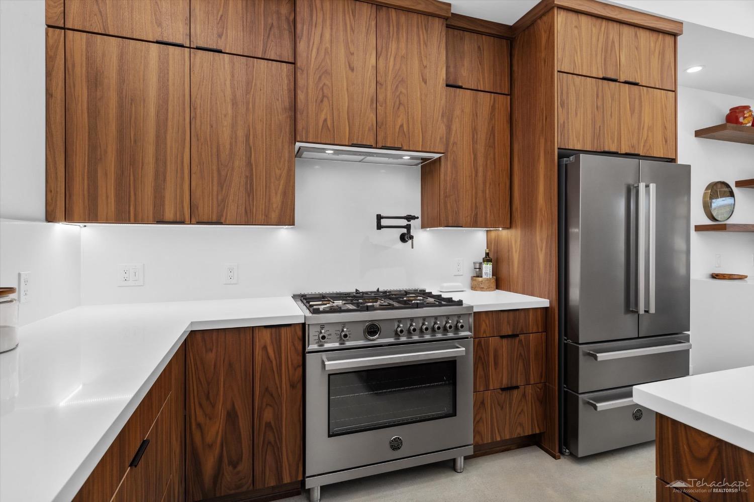 28901 Augusta Way Tehachapi, CA 93561 - Photo 32 of 65 a kitchen with granite countertop a stove and a refrigerator