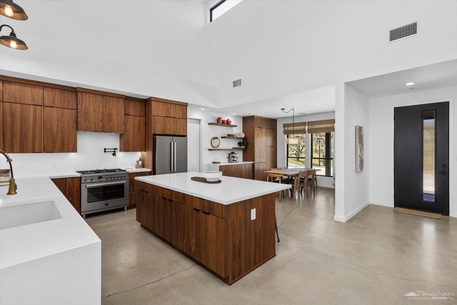 28901 Augusta Way Tehachapi, CA 93561 - Photo 33 of 65 a kitchen that has a lot of cabinets in it and wooden floor