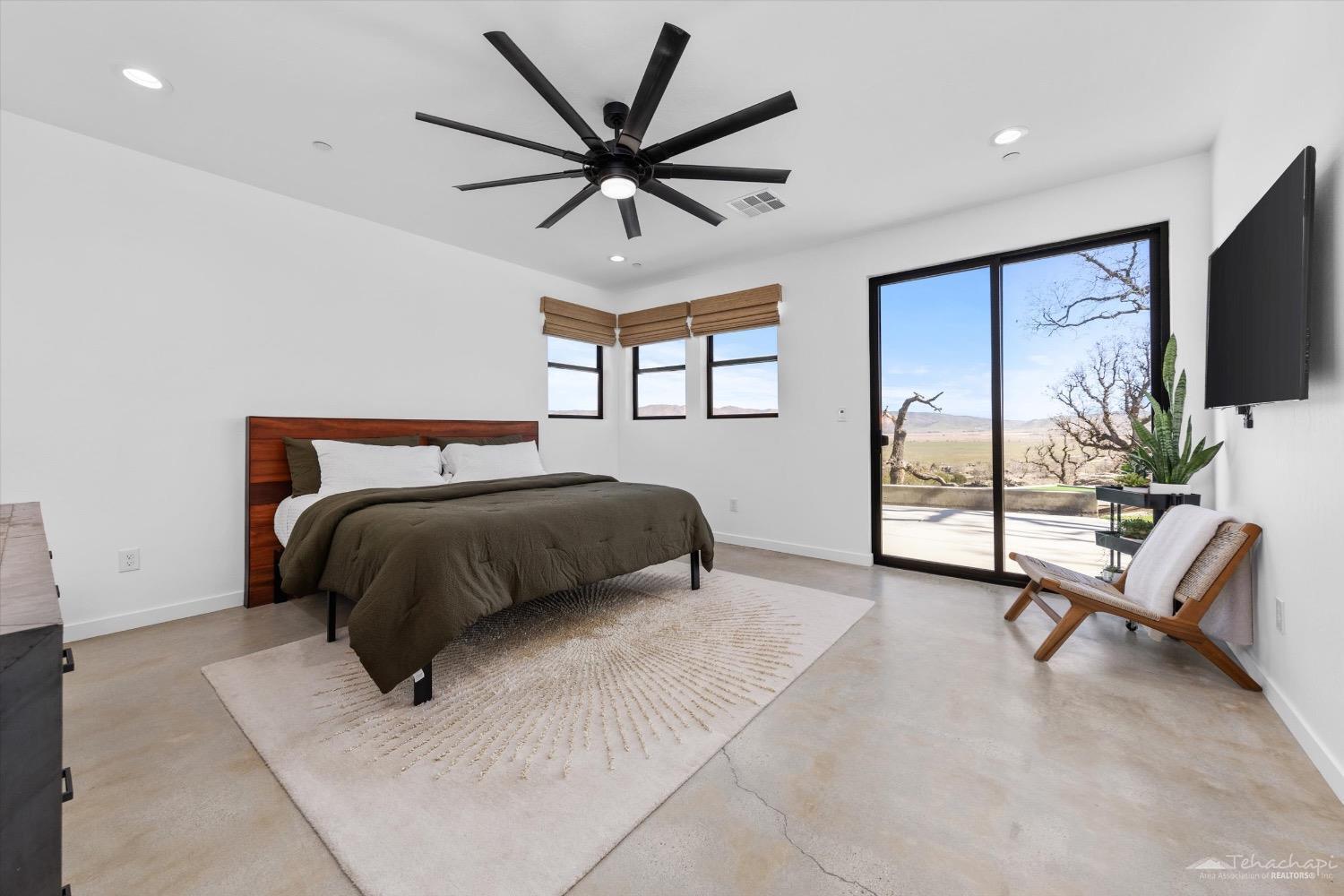 28901 Augusta Way Tehachapi, CA 93561 - Photo 34 of 65 a bedroom with a bed and a flat screen tv