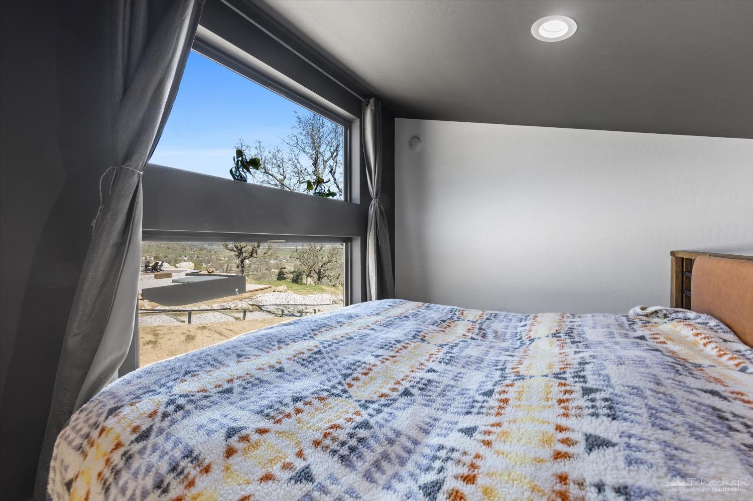 28901 Augusta Way Tehachapi, CA 93561 - Photo 52 of 65 a bedroom with a bed and a painting on the wall