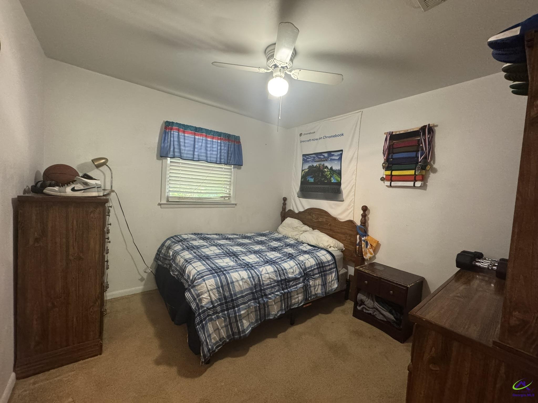 1032 Elberta Road Warner Robins, GA 31093 - Photo 12 of 26 a bedroom with bed table and window