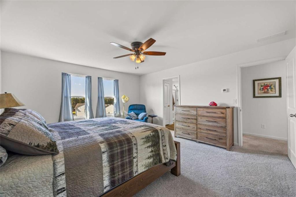 16 Casteel Circle Bethlehem, GA 30620 - Photo 15 of 48 a bedroom with a bed and a chandelier