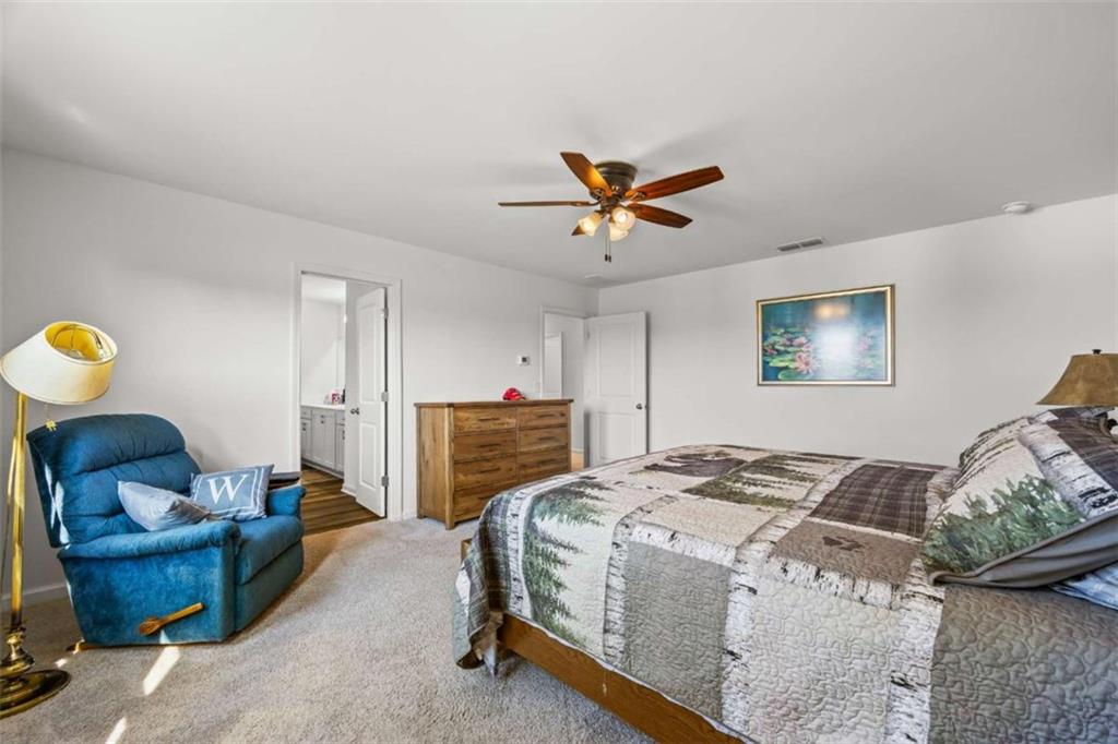 16 Casteel Circle Bethlehem, GA 30620 - Photo 16 of 48 a bedroom with a bed and a chandelier