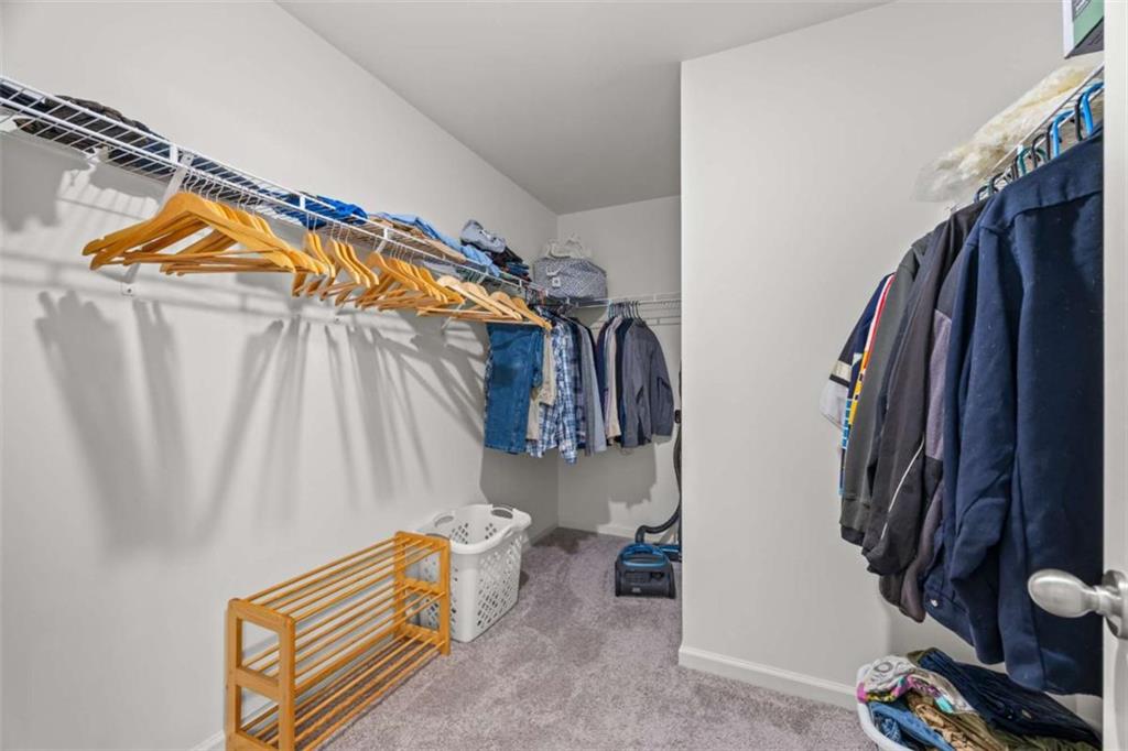 16 Casteel Circle Bethlehem, GA 30620 - Photo 21 of 48 a view of walk in closet with clothes and shoes