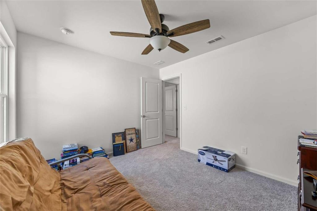 16 Casteel Circle Bethlehem, GA 30620 - Photo 26 of 48 a bedroom with a bed and a chandelier fan