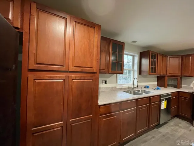 a kitchen with a refrigerator and cabinets