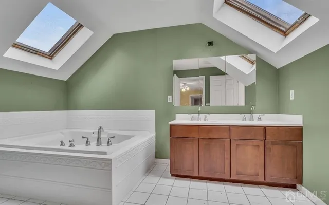a bathroom with a bathtub sink and mirror
