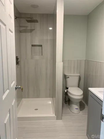 a bathroom with a toilet and shower