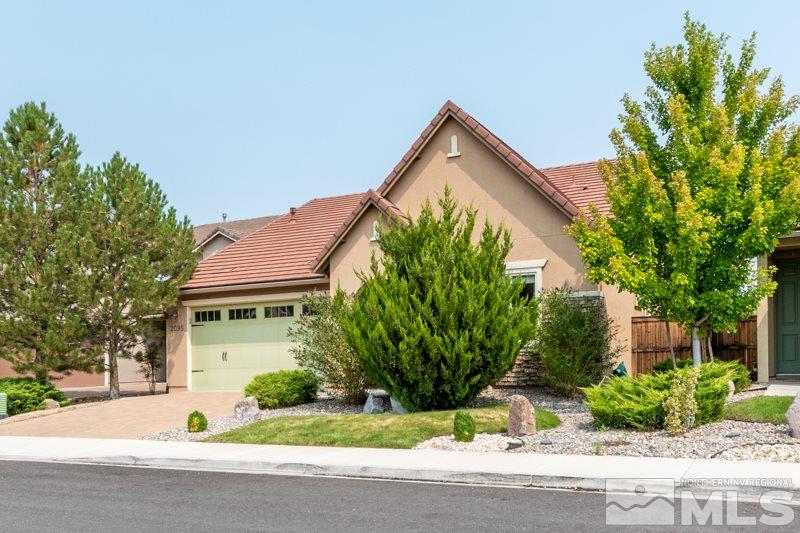 2095 Angel Ridge Drive Reno, NV 89521 - Photo 2 of 30 a front view of a house with a yard and garage