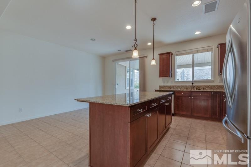 2095 Angel Ridge Drive Reno, NV 89521 - Photo 8 of 30 a kitchen with stainless steel appliances granite countertop a sink a stove and a refrigerator