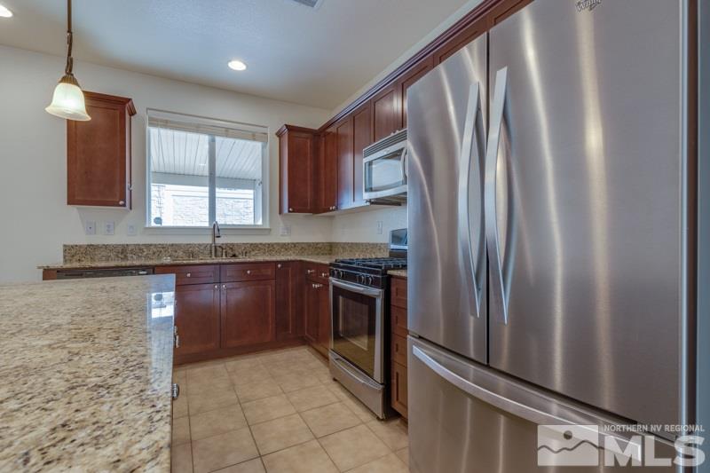 2095 Angel Ridge Drive Reno, NV 89521 - Photo 9 of 30 a kitchen with stainless steel appliances granite countertop a refrigerator and a sink