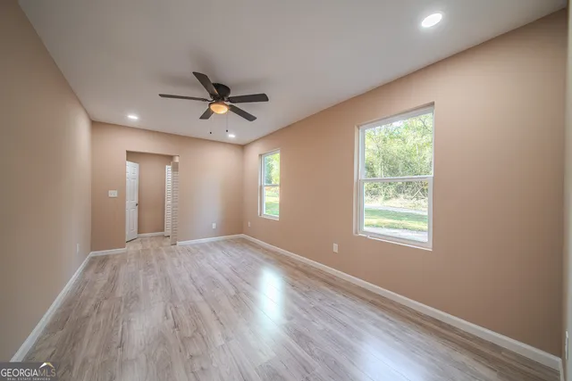 a view of a livingroom with a ceiling fan and window