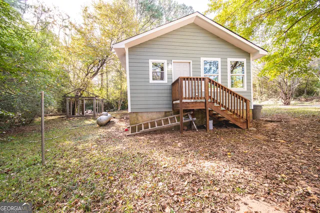 a view of a house with a yard and sitting area