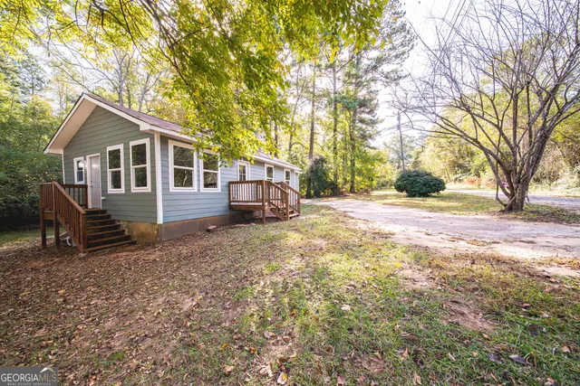 a view of a house with a yard covered in snow