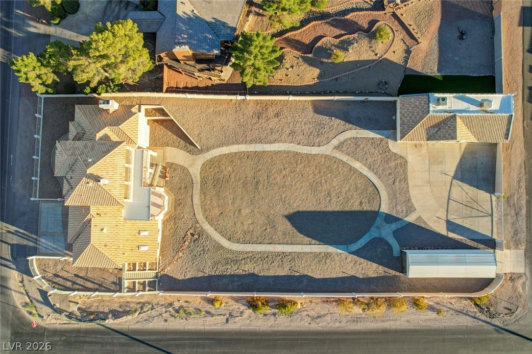 640 North Racetrack Road Henderson, NV 89015 - Photo 7 of 65 An aerial perspective reveals the property's expansive lot, complete with a structured driveway and additional detached shed.