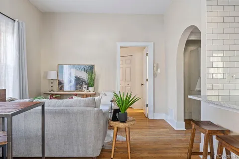 a dining room with furniture and wooden floor