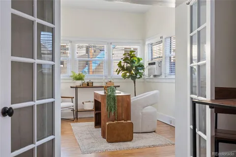 a living room with furniture and a potted plant