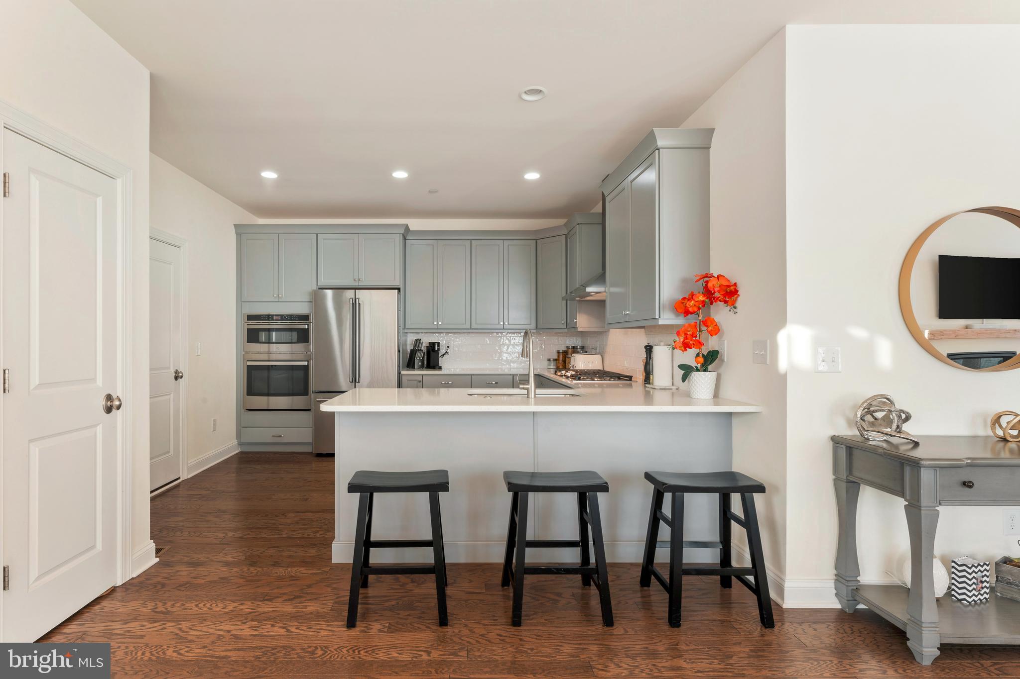 2 Parry Way Warminster, PA 18974 - Photo 10 of 41 a kitchen with stainless steel appliances a dining table chairs and wooden floor