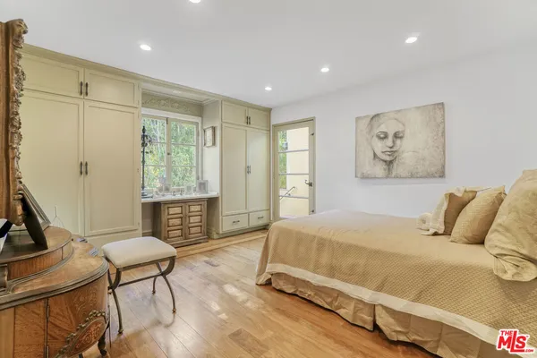 a bedroom with a bed and glass door