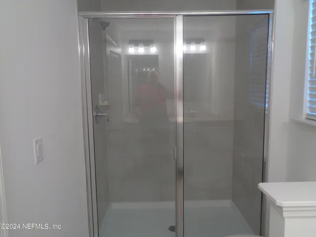 a bathroom with a glass shower door