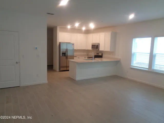 a view of a kitchen with a sink cabinets and window