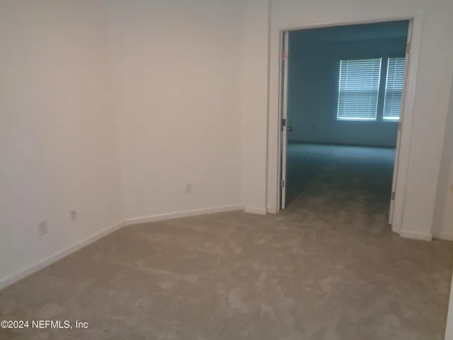 a view of an empty room and closet area