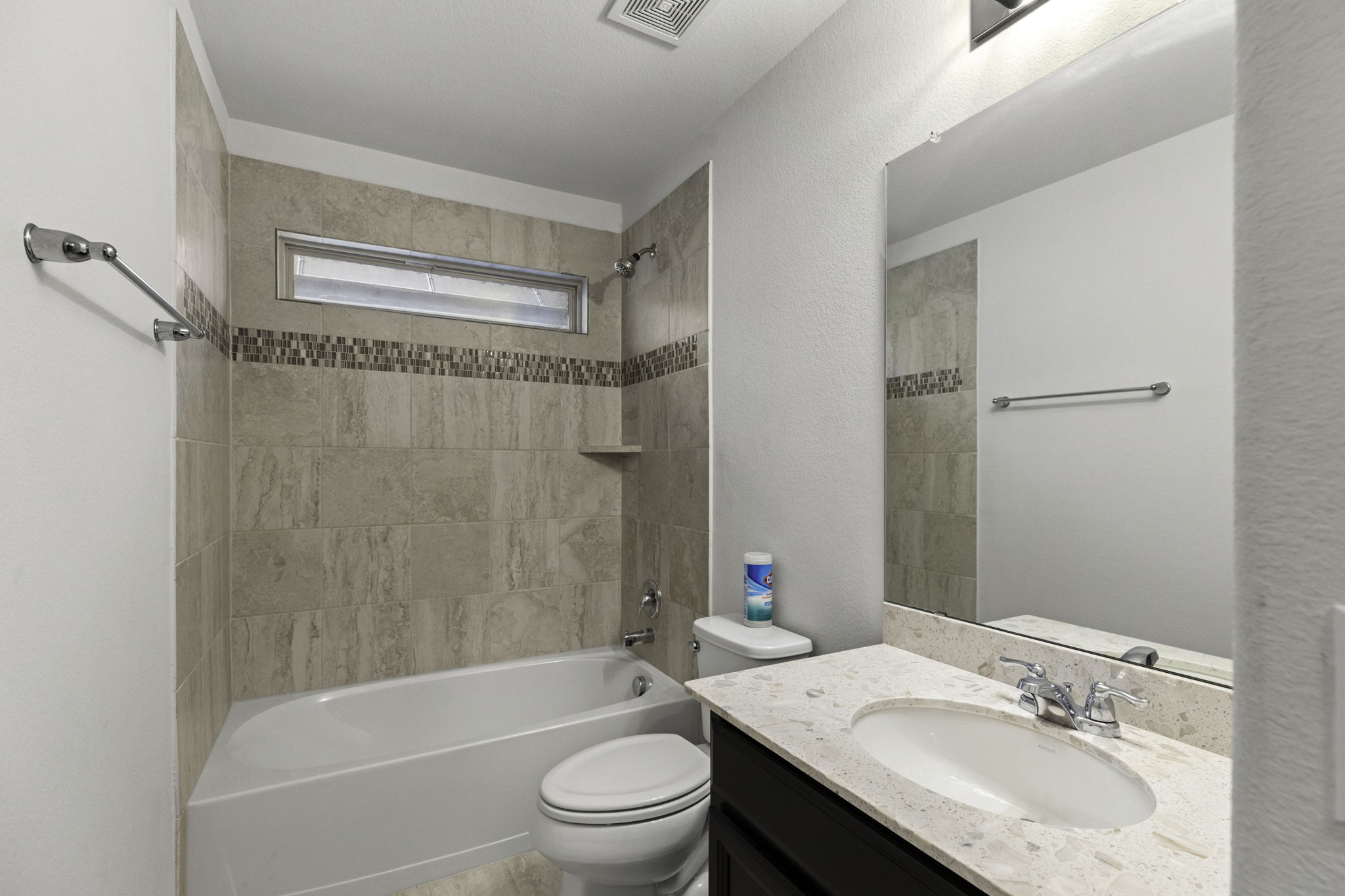 3116 Bragg Place Pflugerville, TX 78660 - Photo 21 of 29 a bathroom with a granite countertop bathtub shower sink vanity mirror and toilet