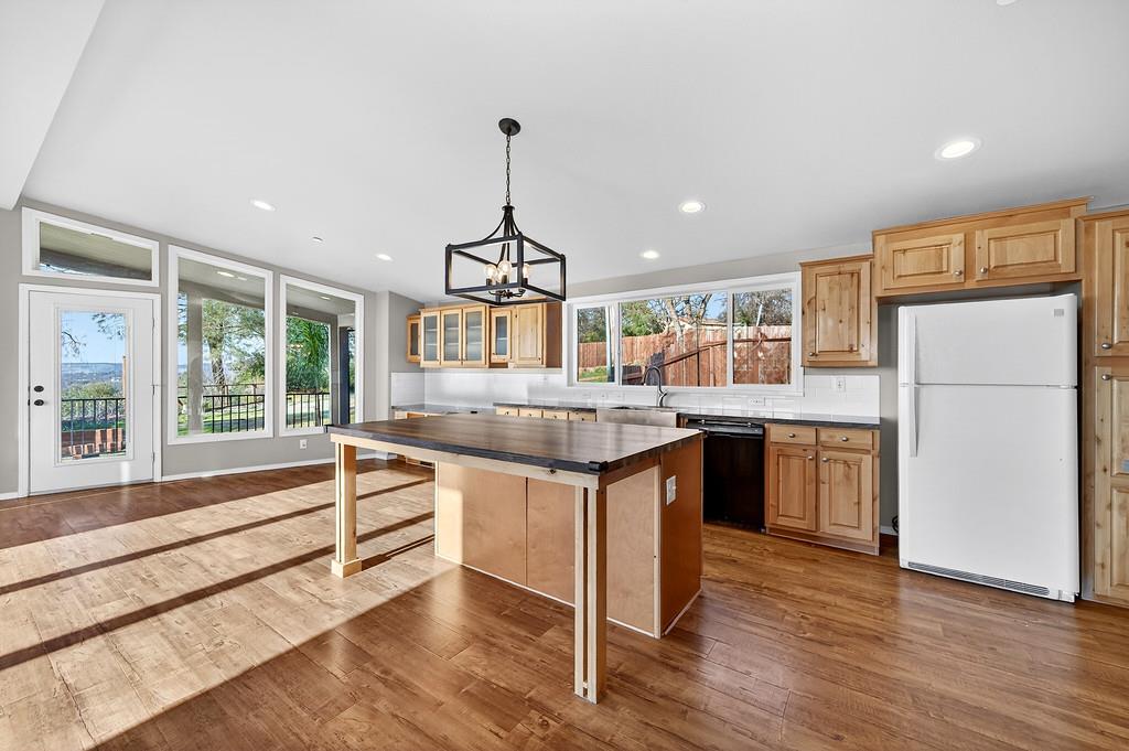 235 Grimont Road Oroville, CA 95966 - Photo 16 of 68 a kitchen with kitchen island a counter top space a sink stainless steel appliances and cabinets