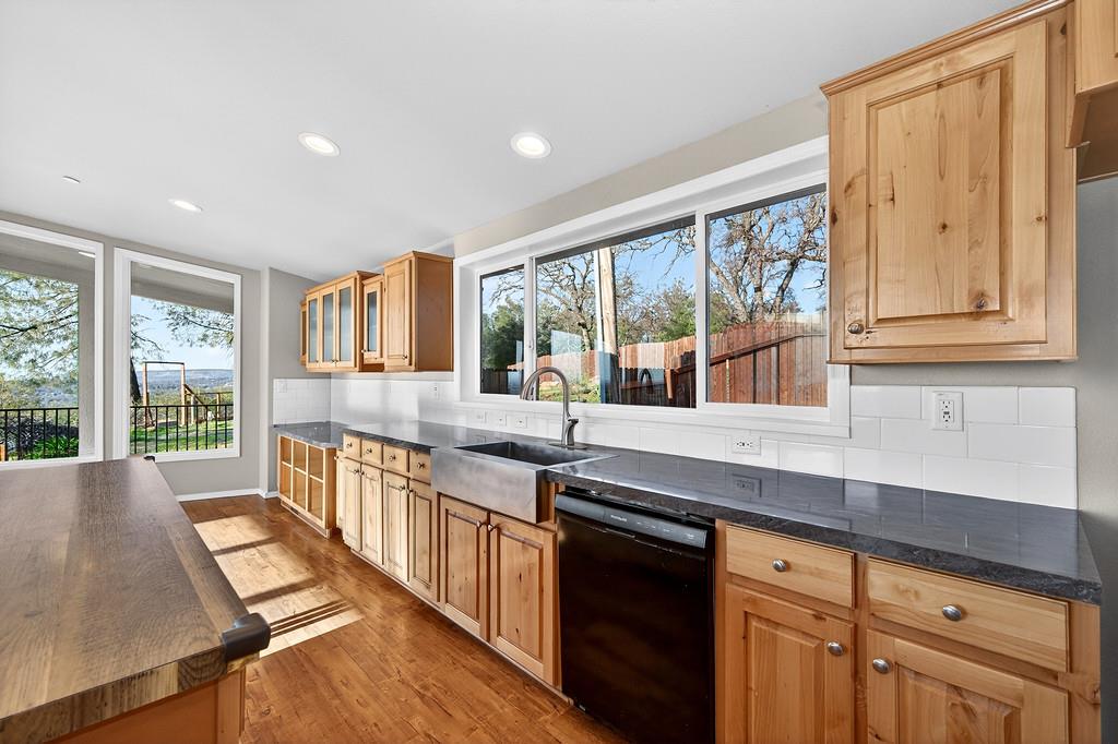 235 Grimont Road Oroville, CA 95966 - Photo 18 of 68 a large kitchen with kitchen island a large window a sink and stainless steel appliances