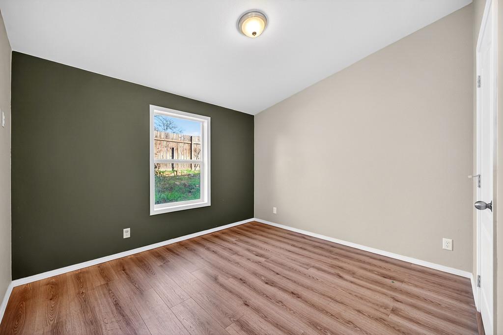 235 Grimont Road Oroville, CA 95966 - Photo 31 of 68 a view of an empty room with wooden floor and a window