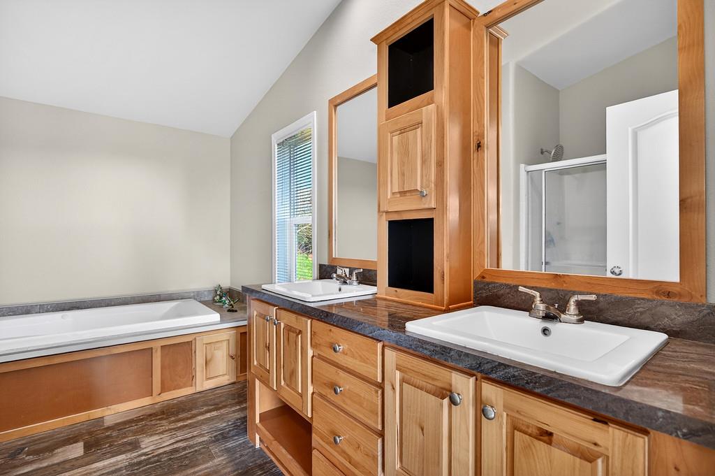 235 Grimont Road Oroville, CA 95966 - Photo 39 of 68 a bathroom with a granite countertop sink and a mirror