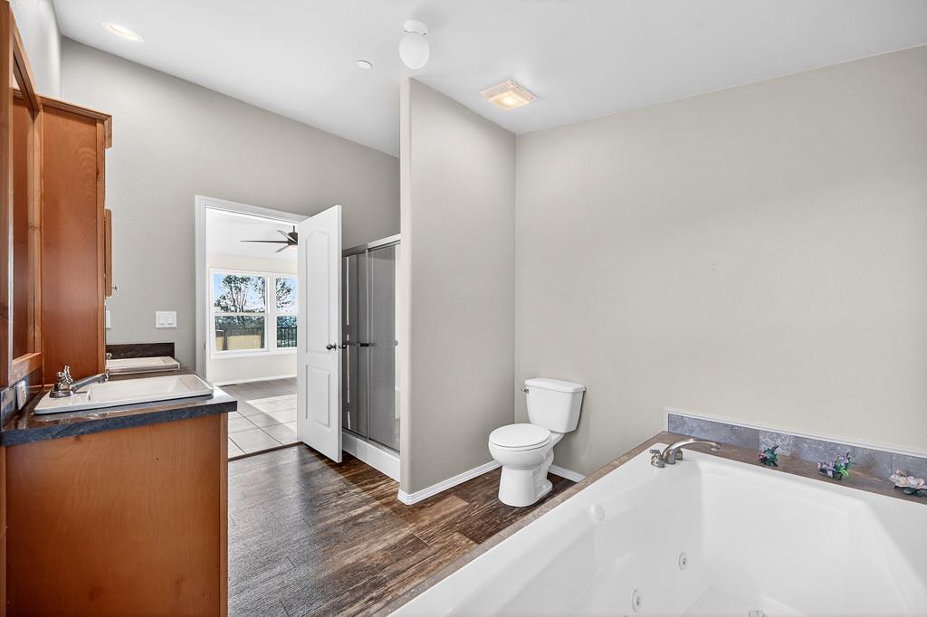 235 Grimont Road Oroville, CA 95966 - Photo 43 of 68 a bathroom with a toilet a sink and a mirror