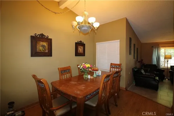 a view of a dining room with furniture and chandelier