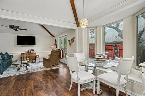 a work room with furniture wooden floor and windows