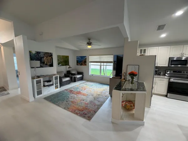 a view of a kitchen with microwave and refrigerator
