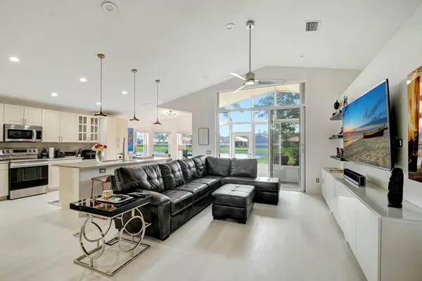 a living room with furniture flat screen tv and white walls