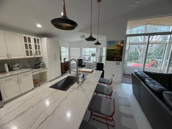 a kitchen with stainless steel appliances kitchen island granite countertop a sink and cabinets
