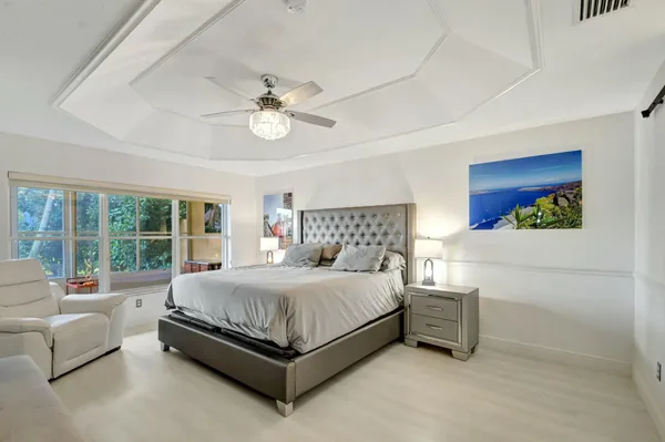 a bedroom with a bed couch and window