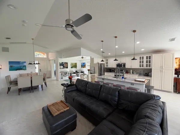 a living room with furniture kitchen view and a table