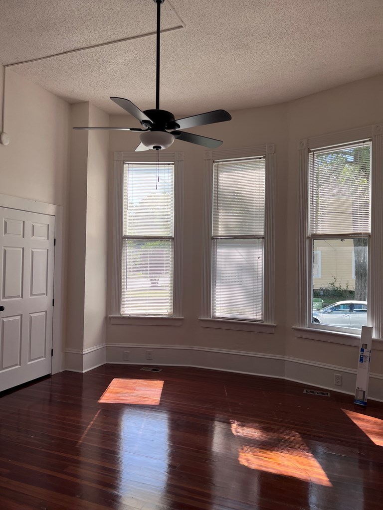 1301 18th Street, Unit A Columbus, GA 31901 - Photo 12 of 21 a view of empty room with wooden floor and fan