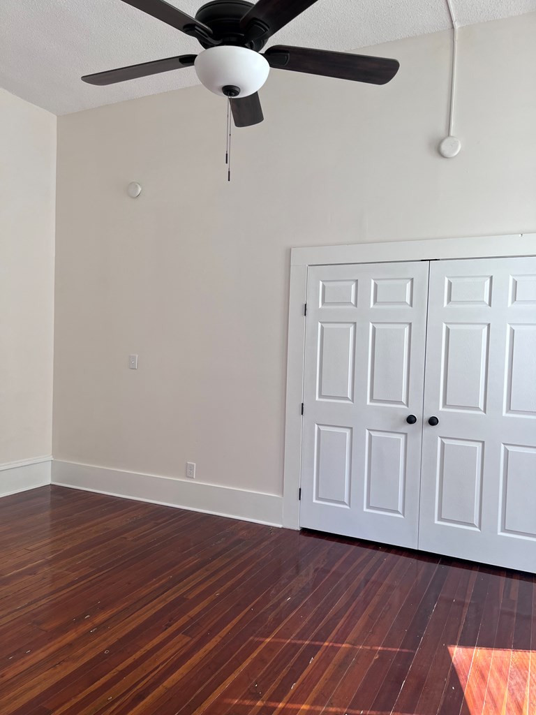 1301 18th Street, Unit A Columbus, GA 31901 - Photo 14 of 21 a view of an empty room with wooden floor