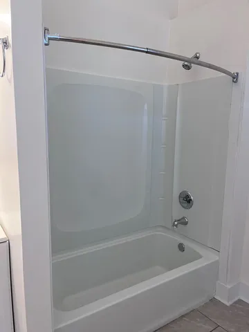 a bathroom with a shower and a bath tub