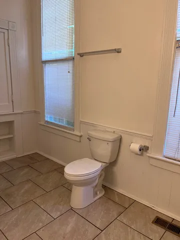 a bathroom with a toilet and a shower