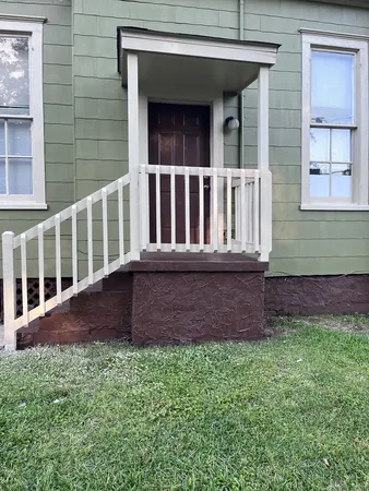 a view of front door of house with yard