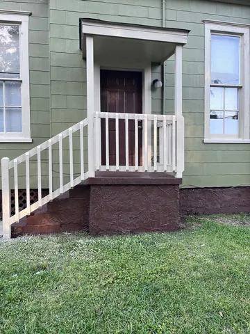 a view of front door of house with yard