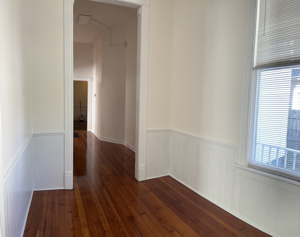 1301 18th Street, Unit A Columbus, GA 31901 - Photo 8 of 21 an empty room with wooden floor and windows